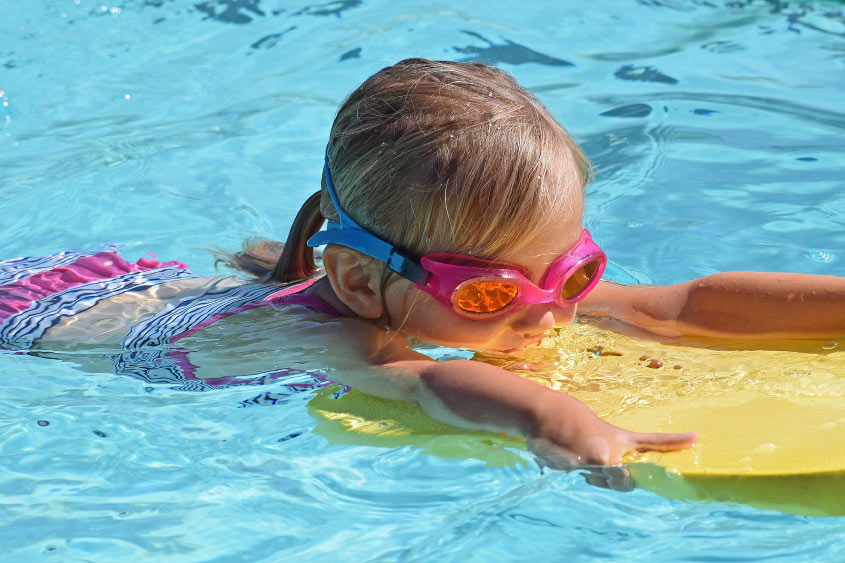 Girl on Bodyboard in Swimming Pool